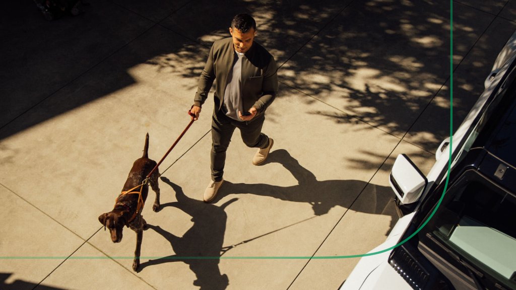 Investor reviewing fixed income strategies on smartphone during a dog walk.