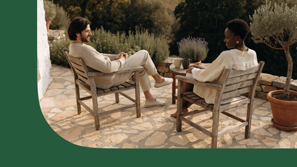 Couple sitting together on a garden terrace in the late afternoon — best bonds to invest in